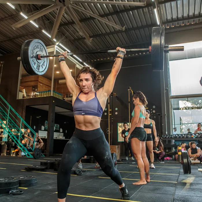 Aluna executando levantamento olímpico em aula de CrossFit em Florianópolis.